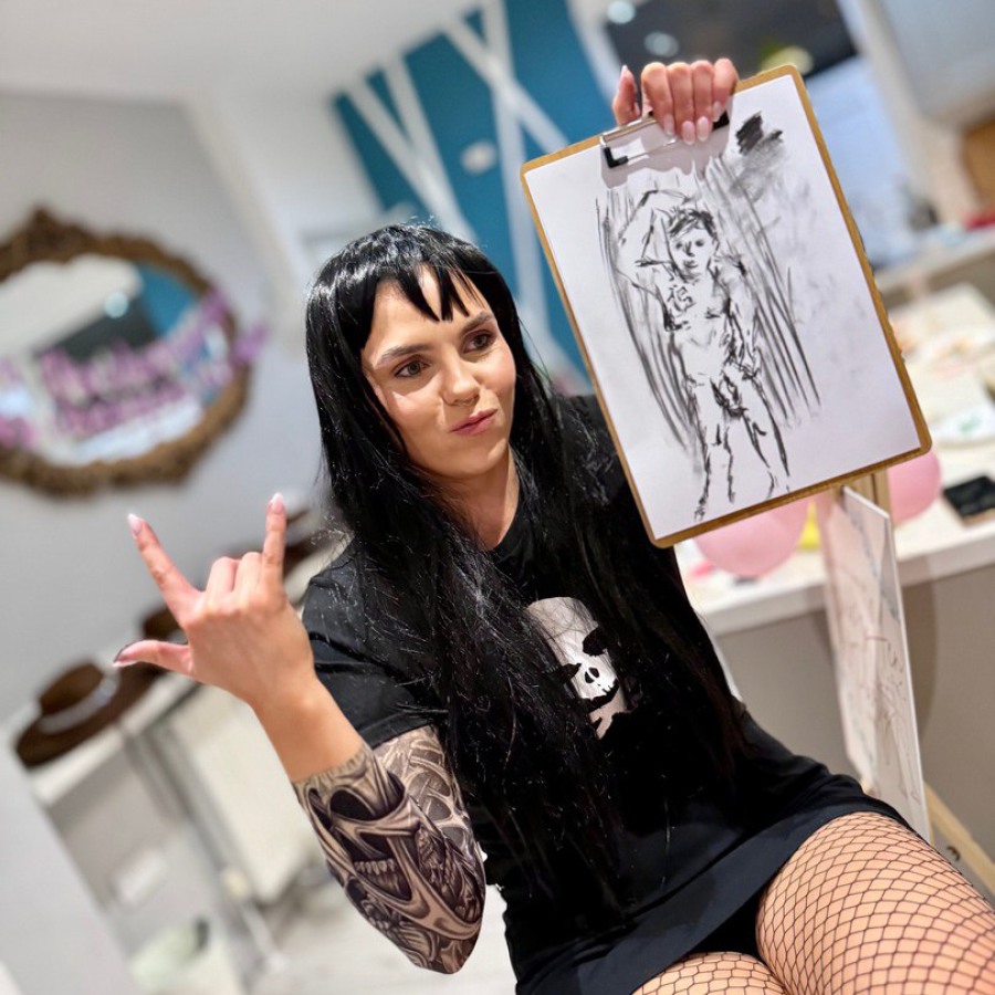 Small group of women at a hen party life drawing session proudly holding their nude art sketches, wearing fun berets.