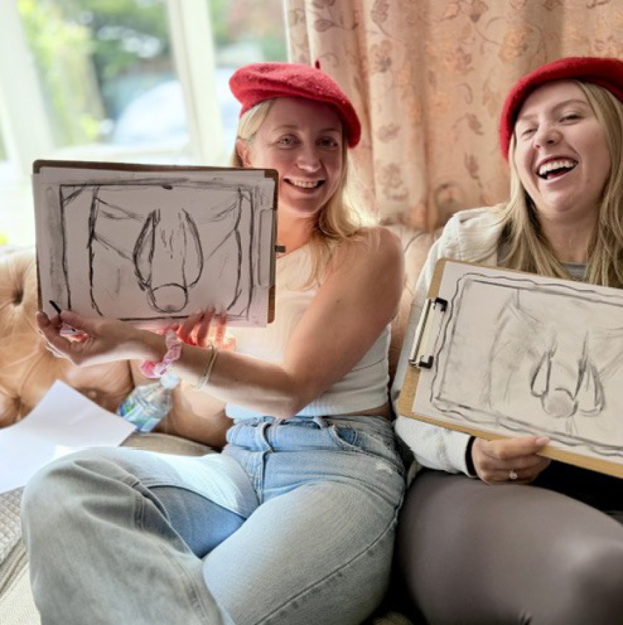 Group photo of a hen party life drawing class with everyone gathered around smiling after the session.