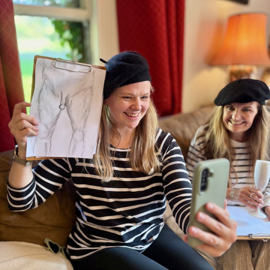 Bride-to-be focused while sketching during private mobile life drawing hen party.