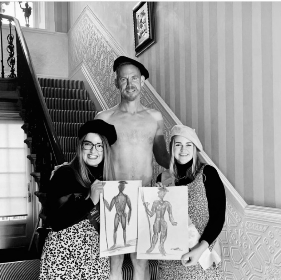 Group of friends smiling with their life drawing art at fun and relaxed hen party session.