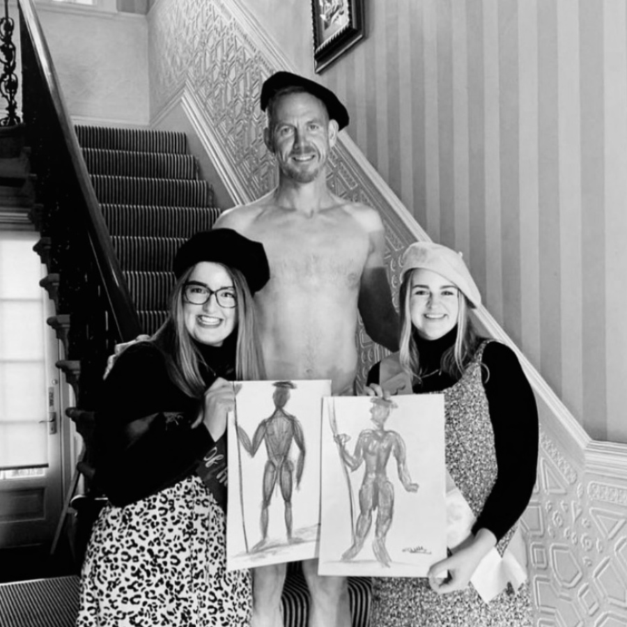 Group of friends smiling with their life drawing art at fun and relaxed hen party session.