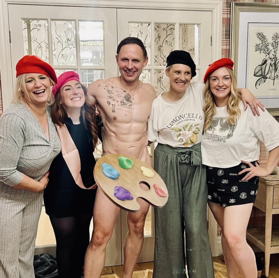 Large group shot of bride tribe holding their nude art drawings after life drawing hen party.